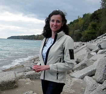 Karen Sands standing on a rocky beach